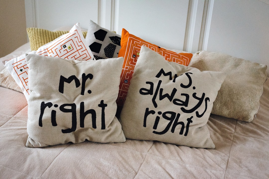 Beige pillows with inscriptions on the bed